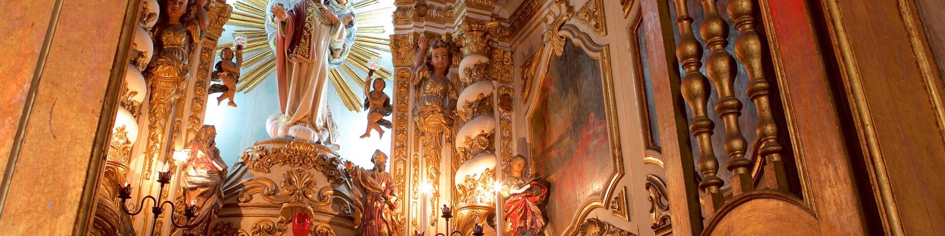 Nossa Senhora de Conceicao da Praia Church featuring a statue or sculpture, religious elements and a church or cathedral