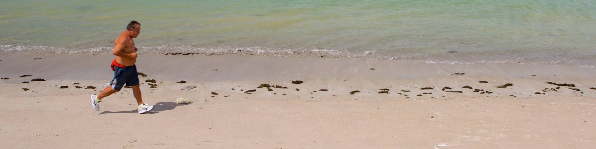 Ponta Verde Beach showing general coastal views and a beach as well as an individual male