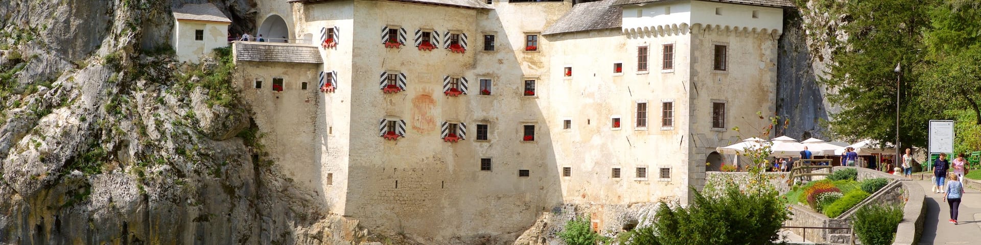Predjama Castle featuring heritage architecture and a coastal town