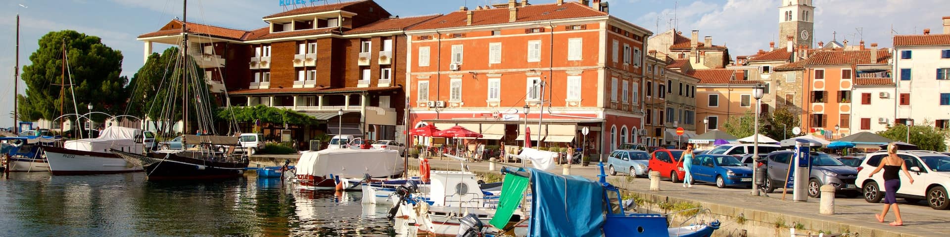 Izola Marina showing a coastal town, boating and a marina