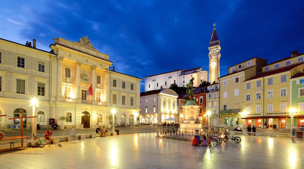 Piran featuring a square or plaza and night scenes as well as a large group of people
