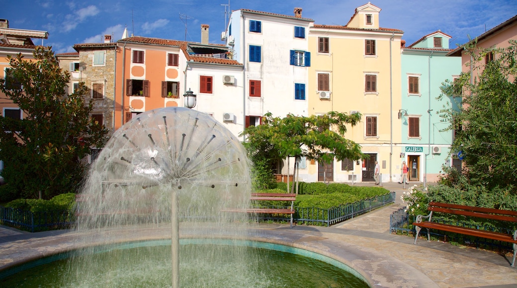 Izola which includes a fountain, a coastal town and a pond