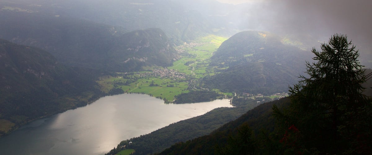 Triglav National Park which includes a lake or waterhole, mist or fog and mountains