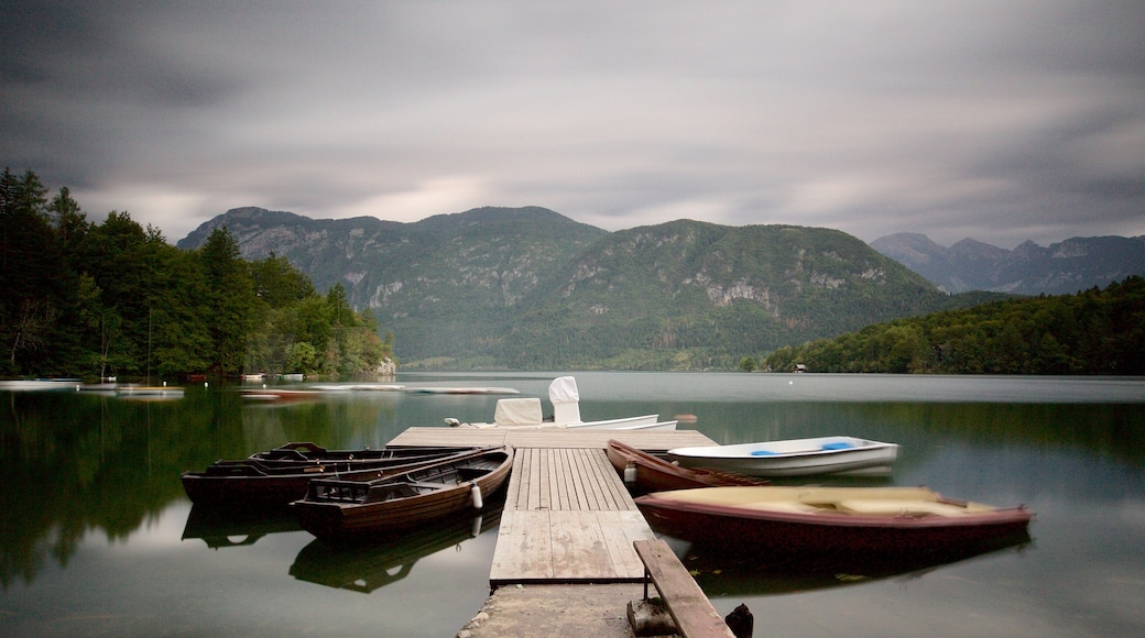 Lake Bohinj which includes mountains, boating and a lake or waterhole