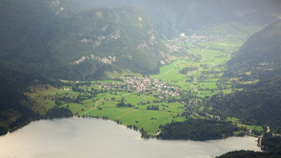Triglav National Park showing a lake or waterhole, a small town or village and mountains