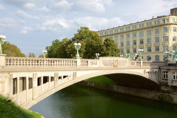 Dragon Bridge featuring a bridge, a river or creek and heritage architecture