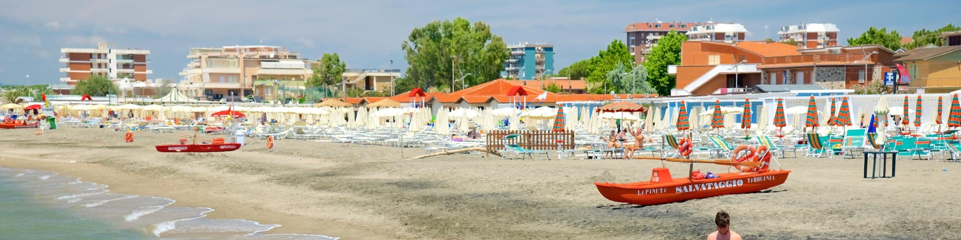 Tarquinia featuring swimming, a coastal town and a sandy beach