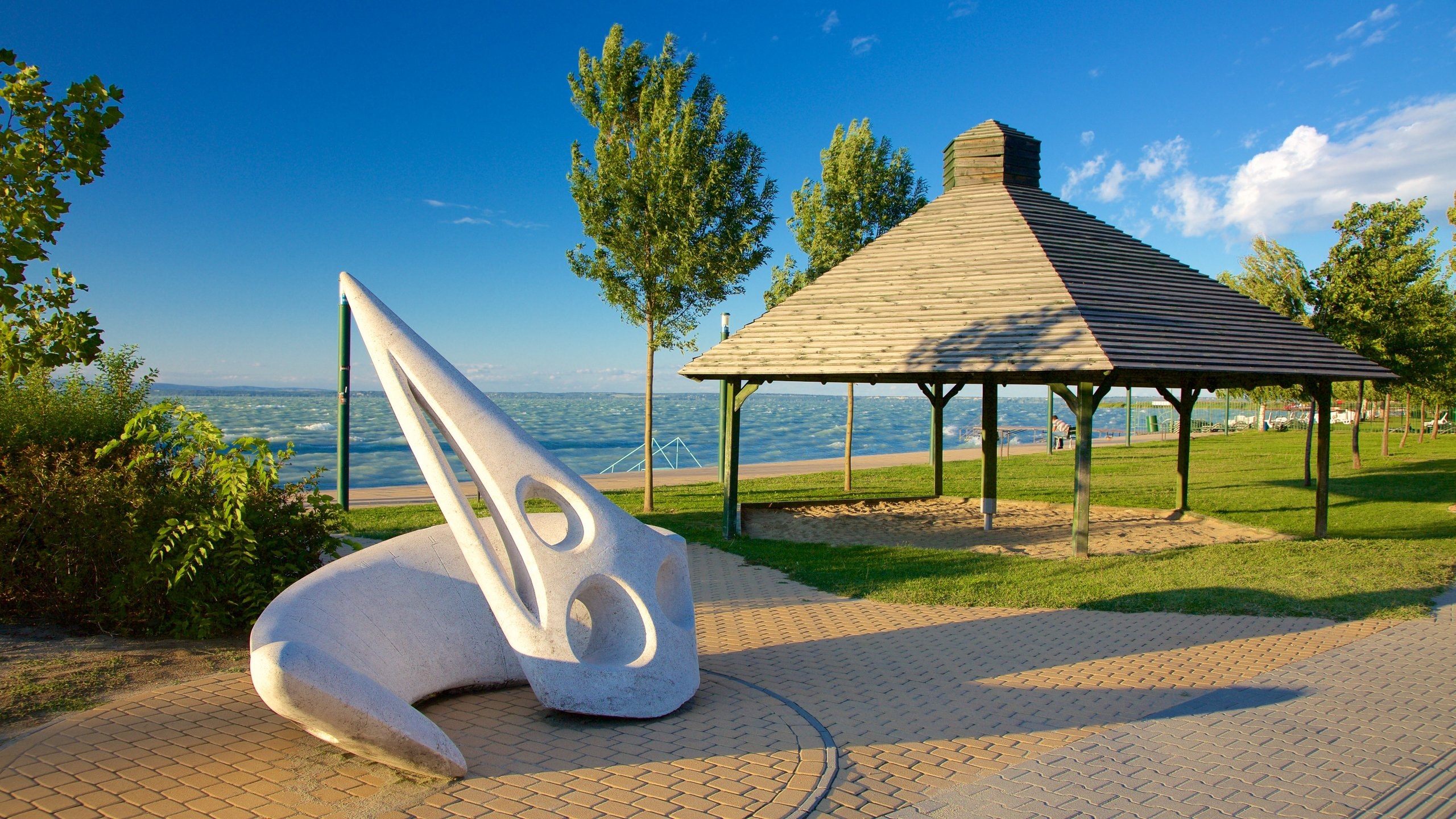 Siofok which includes outdoor art, a park and general coastal views