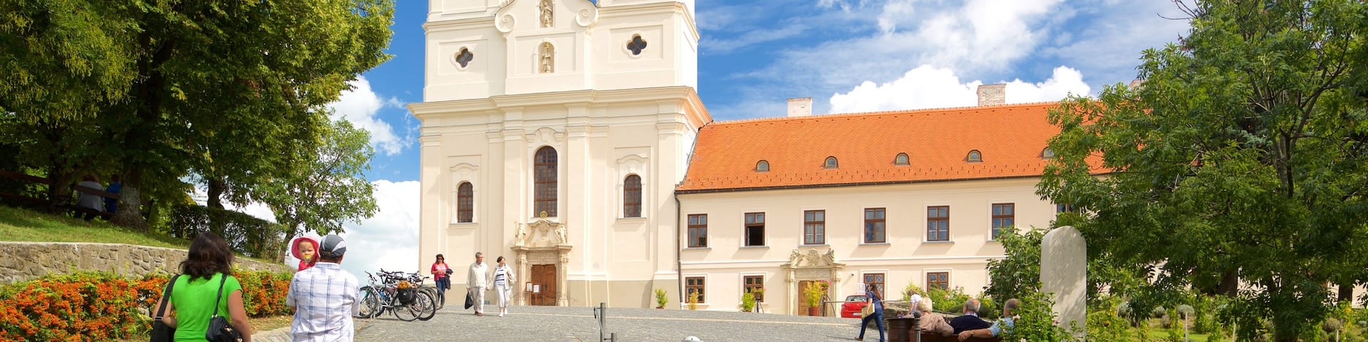 Tihany Abbey showing heritage architecture and a church or cathedral as well as a couple