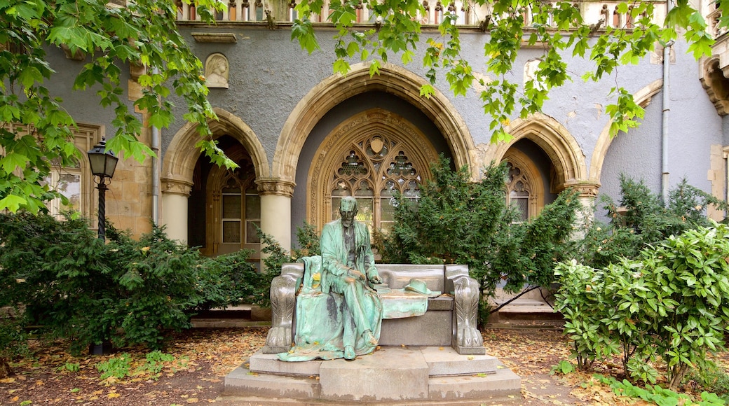 Vajdahunyad Castle showing a statue or sculpture, a garden and a castle