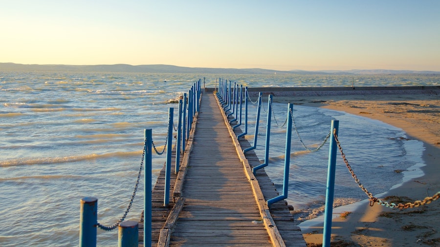 Golden Shore which includes a beach, a sunset and views