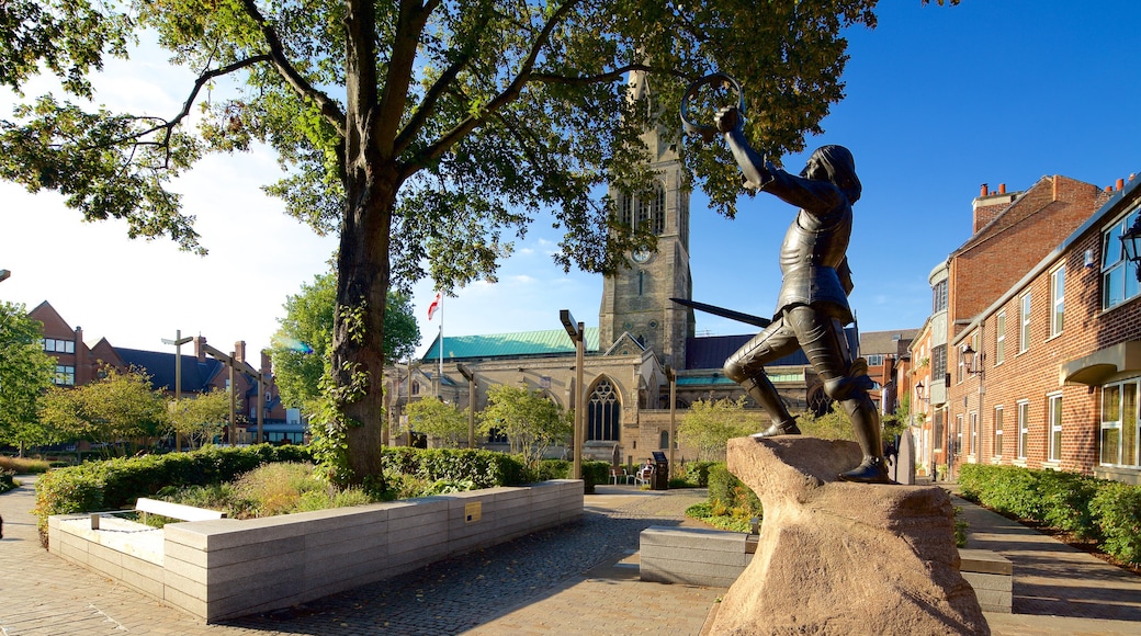 Leicester Cathedral which includes a statue or sculpture, a church or cathedral and a square or plaza