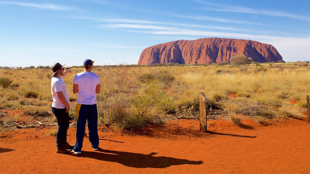 Uluru featuring desert views and landscape views as well as a couple