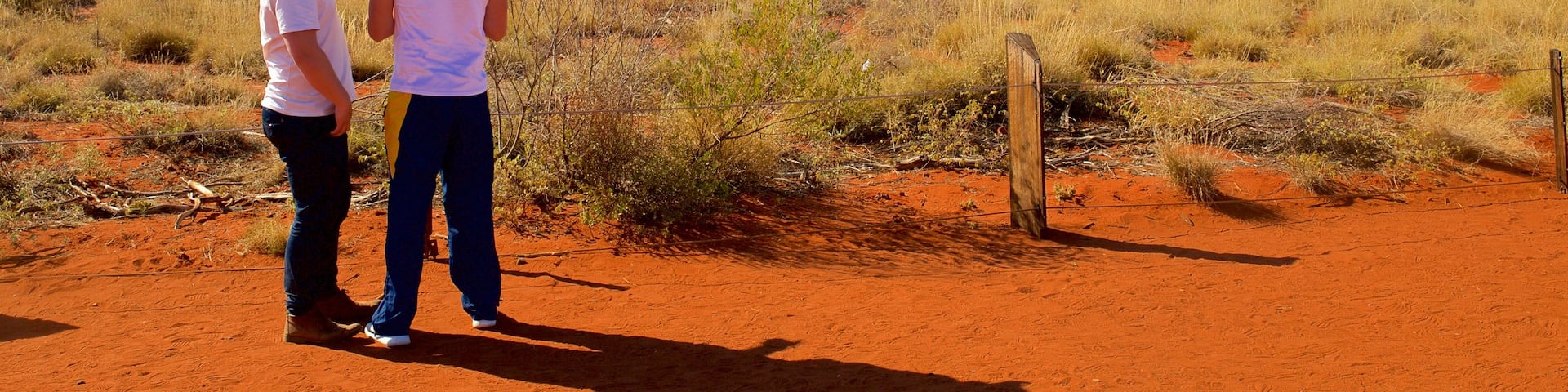 Uluru which includes landscape views and desert views as well as a couple