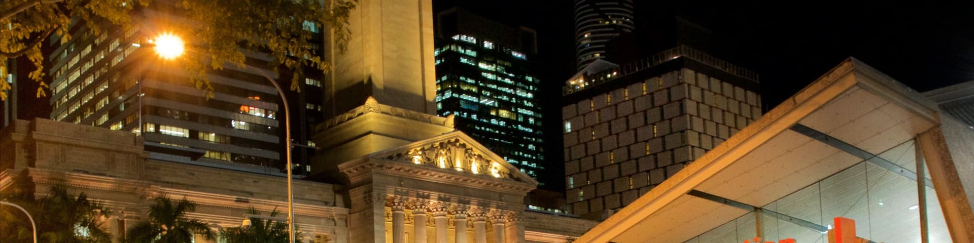 King George Square which includes a city, night scenes and street scenes