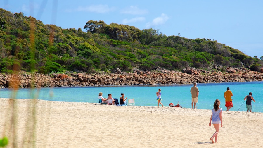 Naturaliste which includes rugged coastline and a sandy beach as well as a small group of people