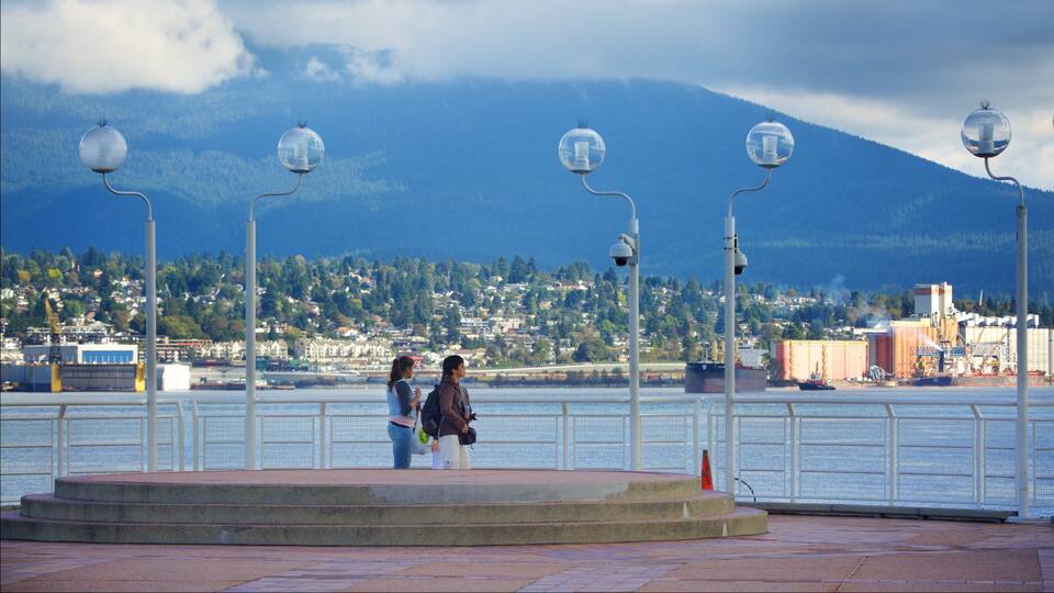 Vancouver Waterfront which includes a bay or harbor as well as a small group of people