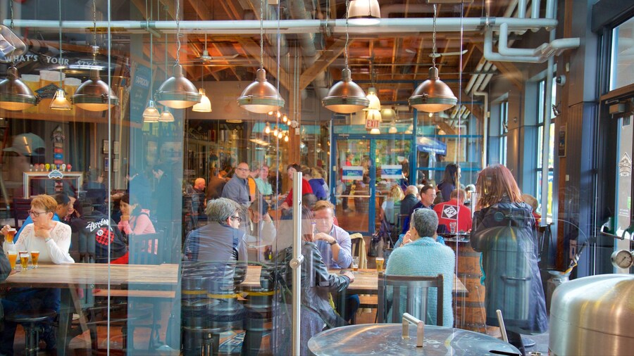 Interior view of Granville Island Public Market with visitors enjoying food and shopping in Vancouver, British Columbia.
