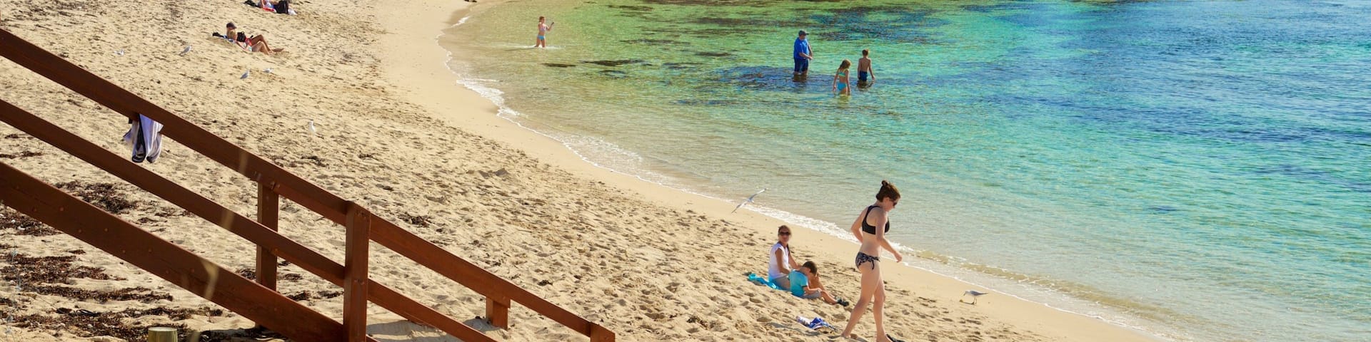 Prevelly Beach which includes a sandy beach, rocky coastline and a bay or harbour