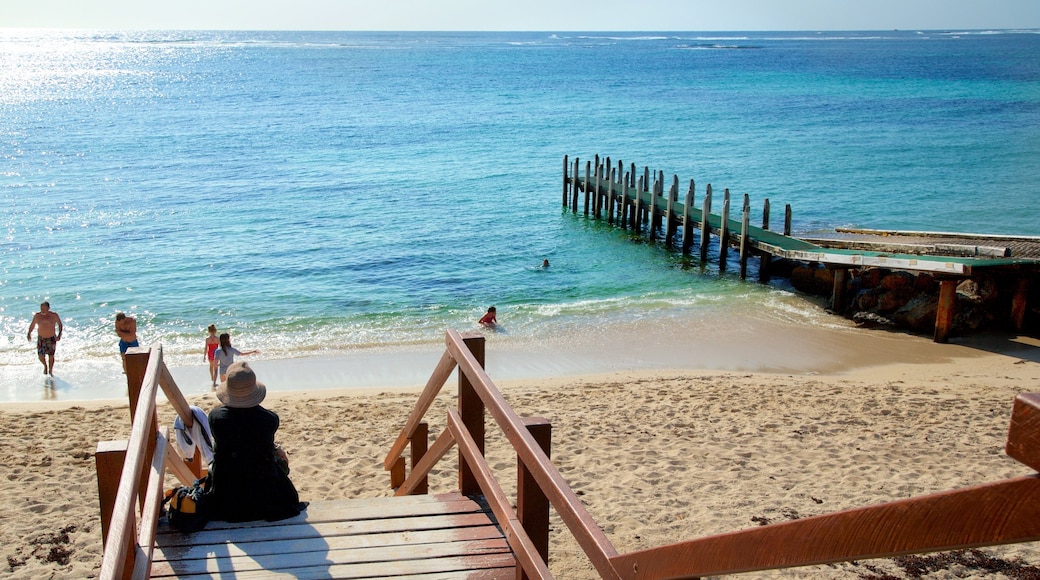 Prevelly Beach which includes a sandy beach and a bay or harbour as well as a small group of people