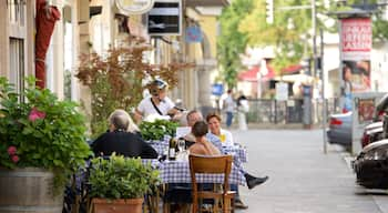 Charlottenburg featuring street scenes and outdoor eating as well as a small group of people