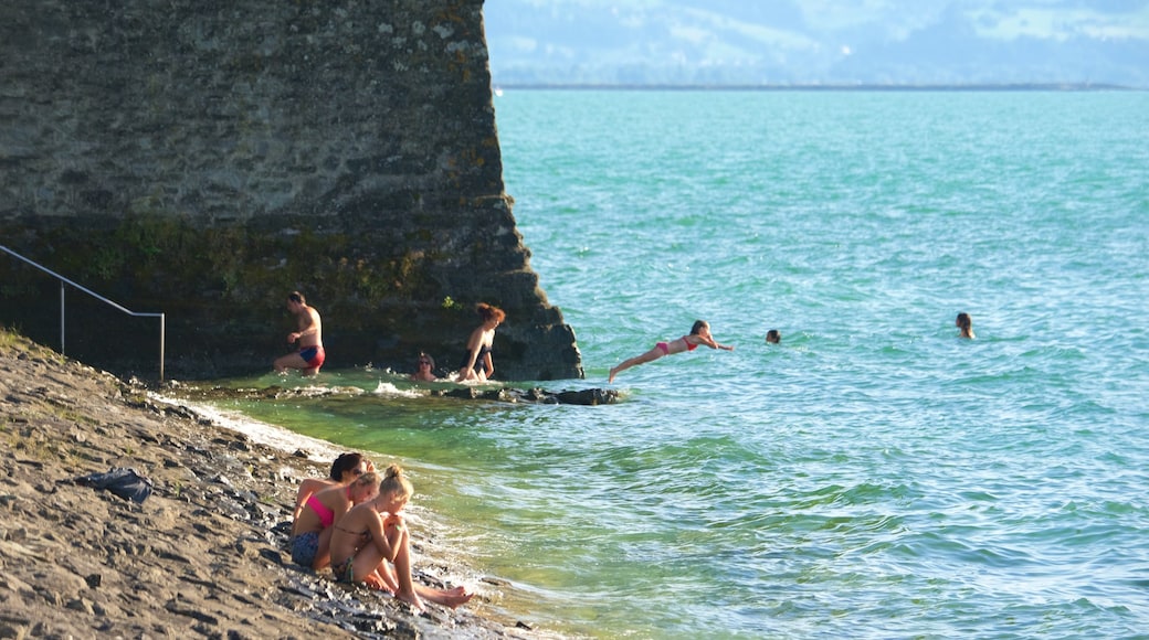 Lindau which includes rocky coastline as well as a small group of people