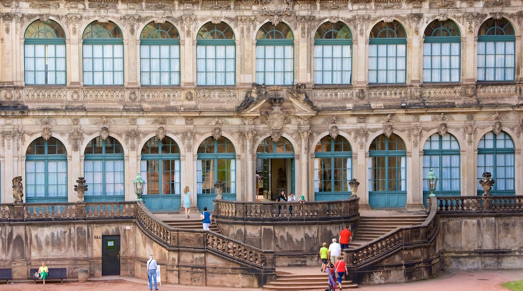 Zwinger Palace showing a castle as well as a small group of people