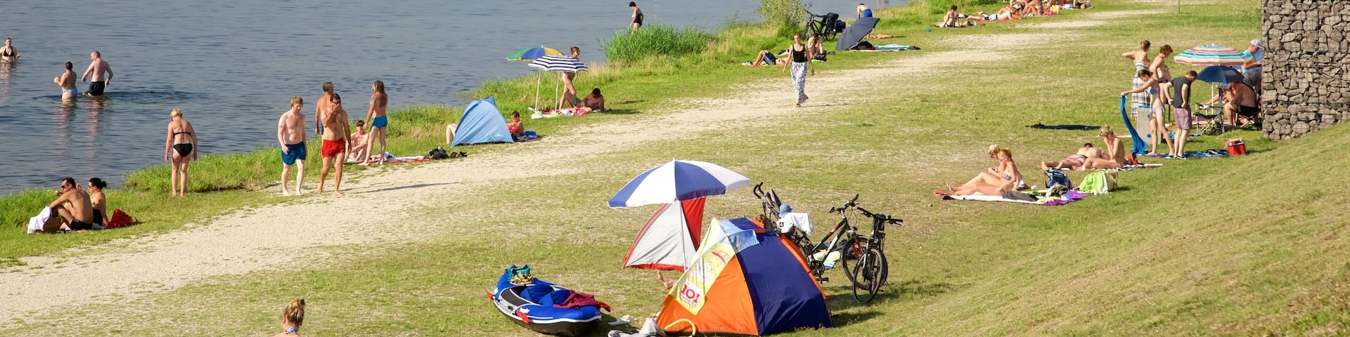 Cospudener Lake showing a lake or waterhole as well as a large group of people