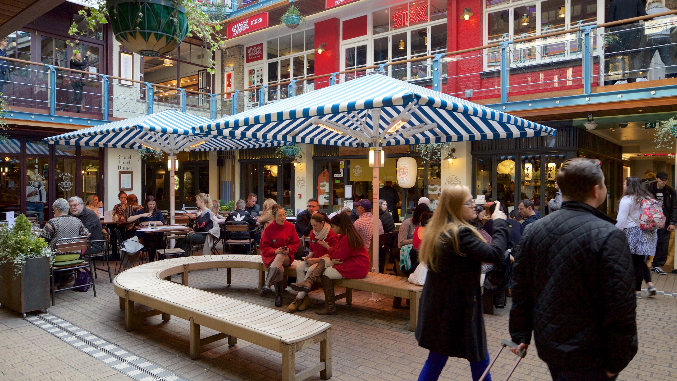 Carnaby Street which includes a square or plaza as well as a large group of people