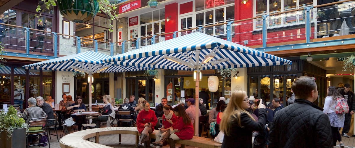 Carnaby Street featuring a square or plaza as well as a large group of people