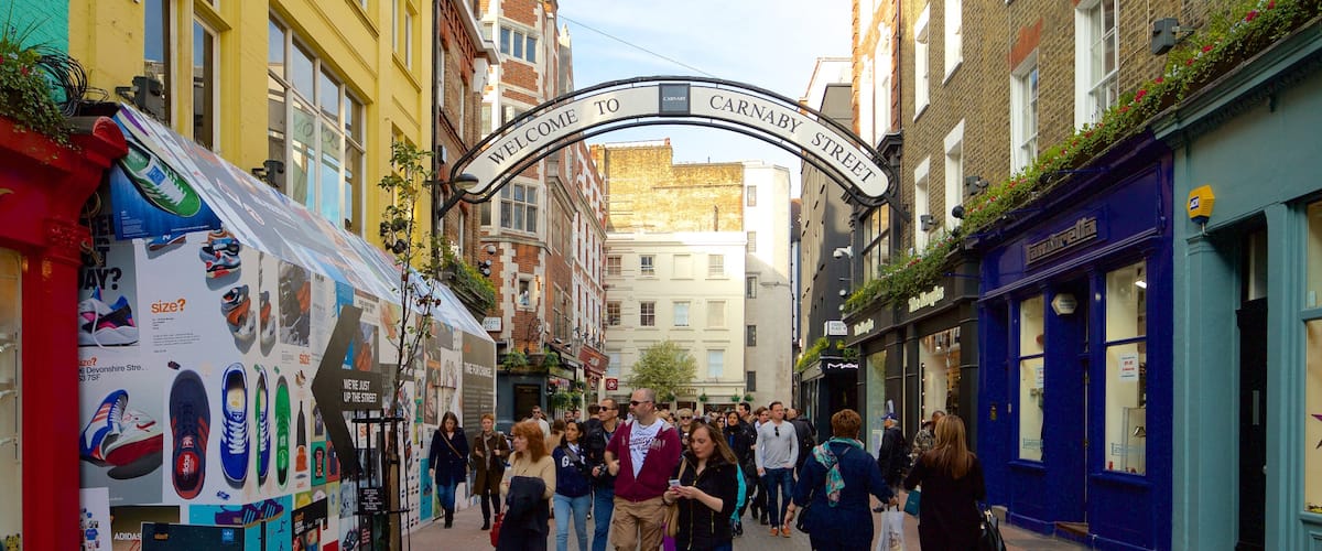Carnaby Street showing a square or plaza and heritage architecture as well as a large group of people