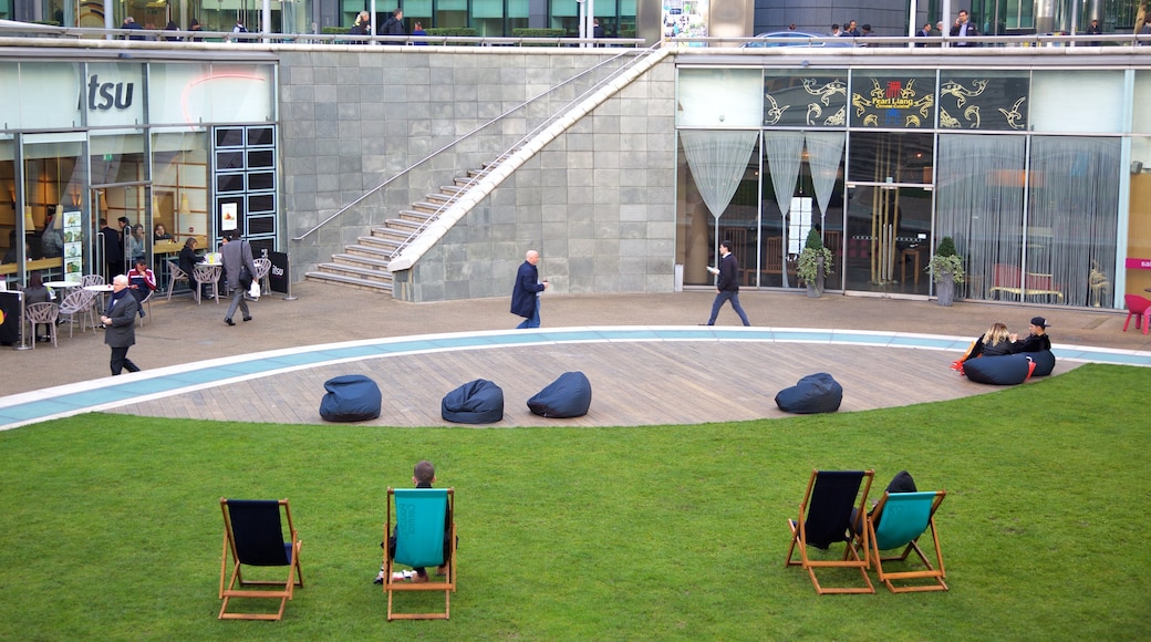 Paddington showing a square or plaza as well as a small group of people