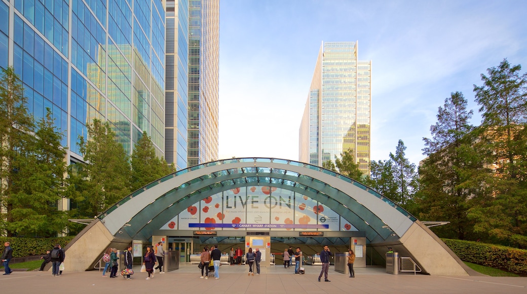 Canary Wharf showing a skyscraper and a city as well as a small group of people