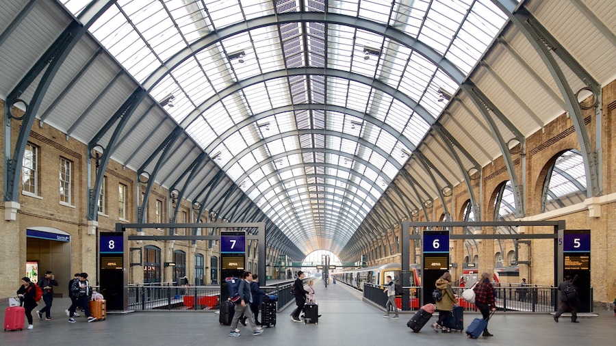 Kings Cross - St. Pancras featuring heritage architecture and interior views as well as a small group of people