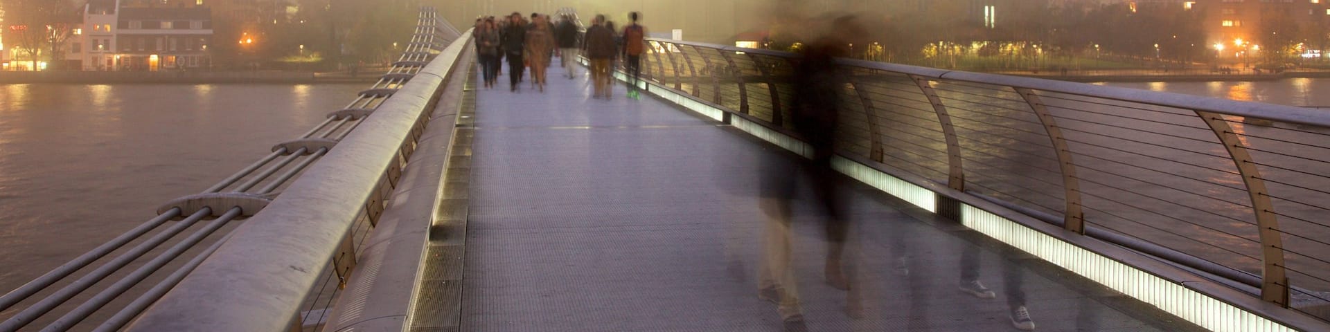 London Millennium Footbridge showing a city, mist or fog and a river or creek