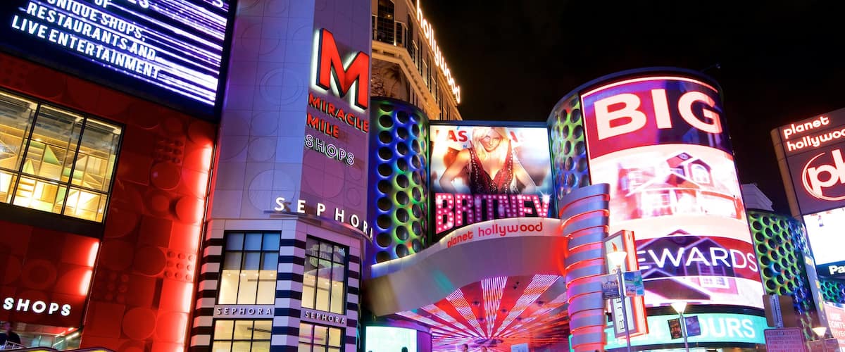 Centro comercial Miracle Mile Shops ofreciendo escenas nocturnas, un casino y señalización