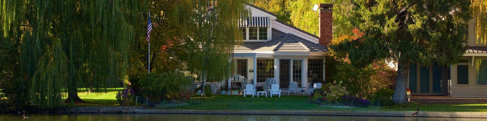 Drake Park which includes autumn leaves, a house and a pond