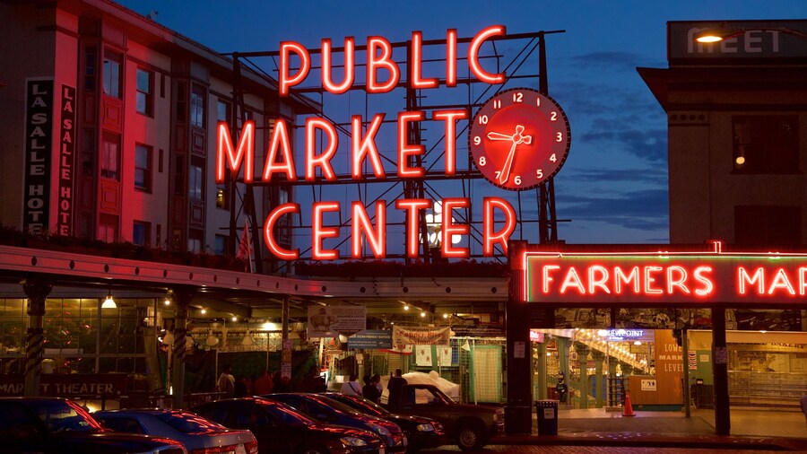 Pike Place Market neon sign illuminated at night in Seattle, Washington.