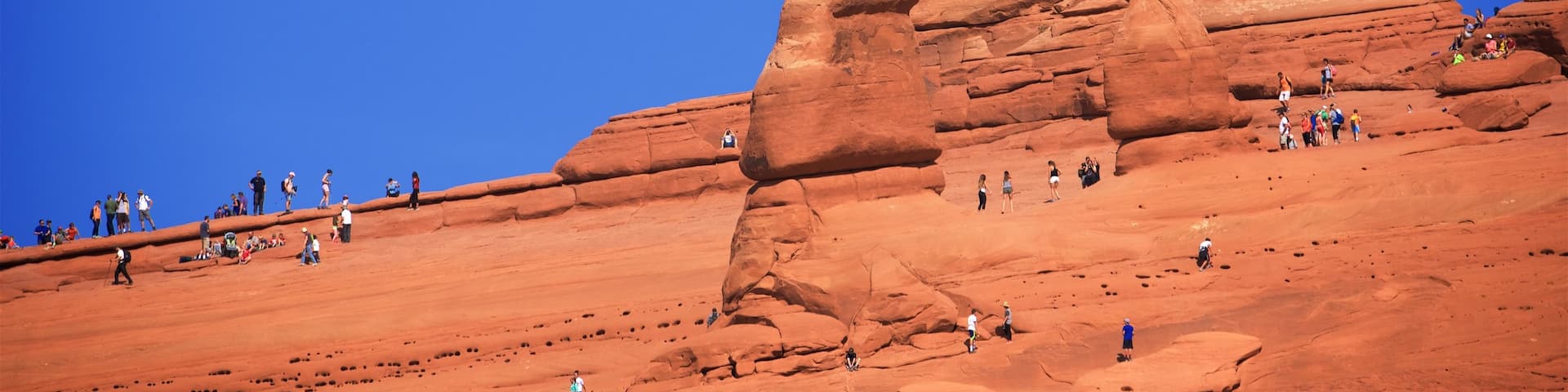 Moab featuring desert views as well as a large group of people