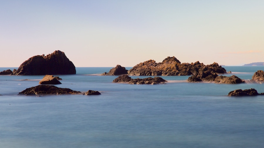 Deception Pass State Park showing a bay or harbor, rocky coastline and a sunset