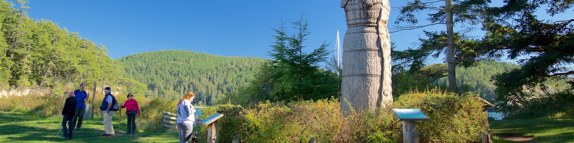 Deception State Park featuring a garden and a statue or sculpture as well as a small group of people