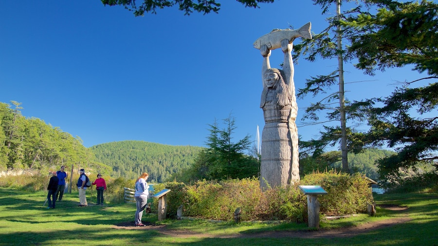 Deception State Park featuring a garden and a statue or sculpture as well as a small group of people
