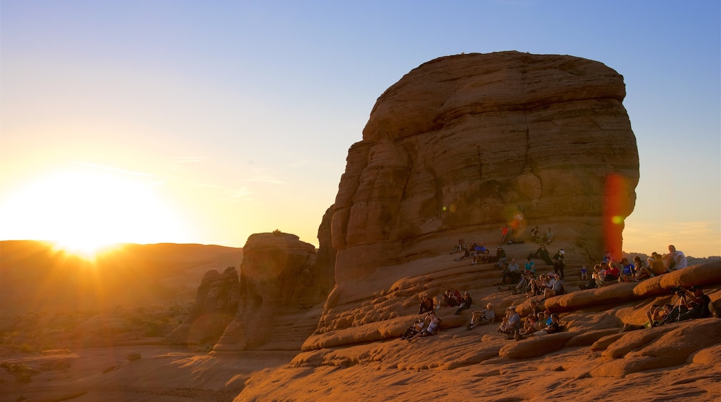 Delicate Arch featuring tranquil scenes, a sunset and landscape views