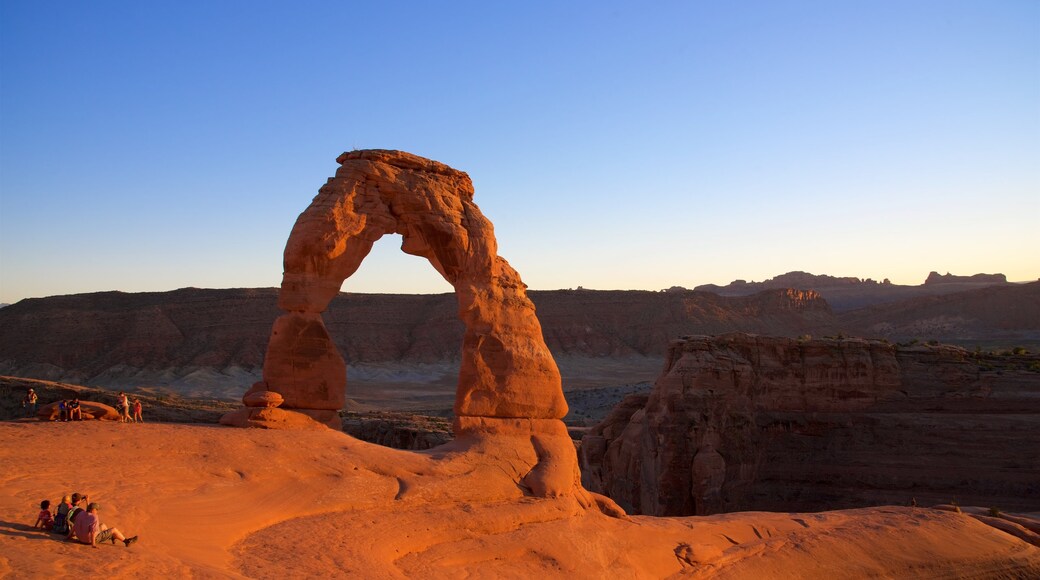 Delicate Arch showing hiking or walking, a gorge or canyon and landscape views