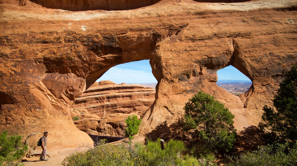 Partition Arch which includes tranquil scenes and hiking or walking as well as an individual male