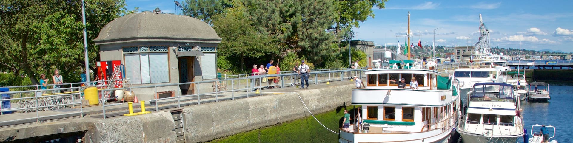 Hiram M. Chittenden Locks featuring a river or creek and boating as well as a small group of people