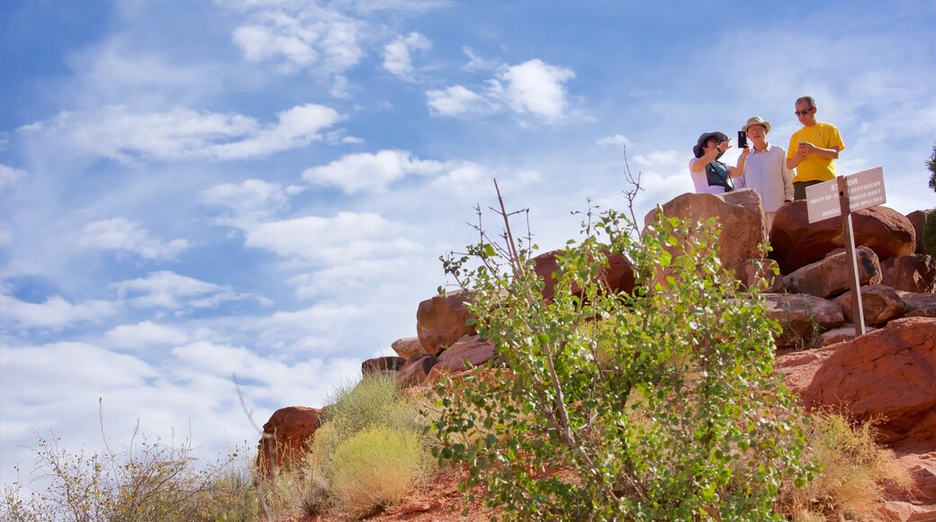 Moab which includes hiking or walking and tranquil scenes as well as a small group of people