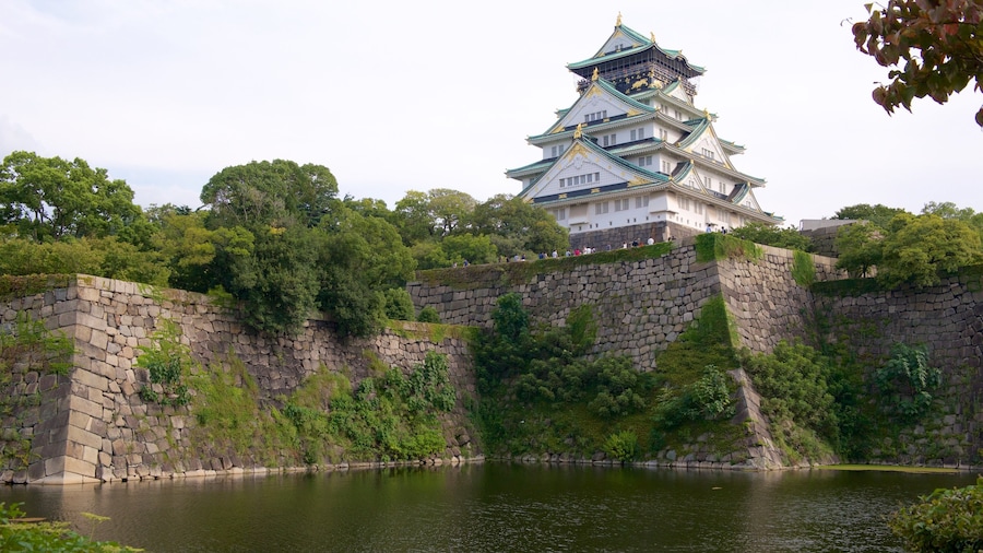 Osaka Castle surrounded by a moat and lush greenery in Osaka, Japan.