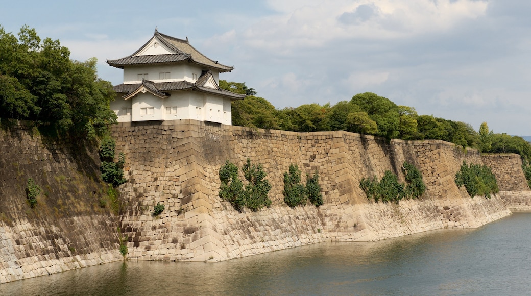 Osaka Castle showing heritage elements and a lake or waterhole