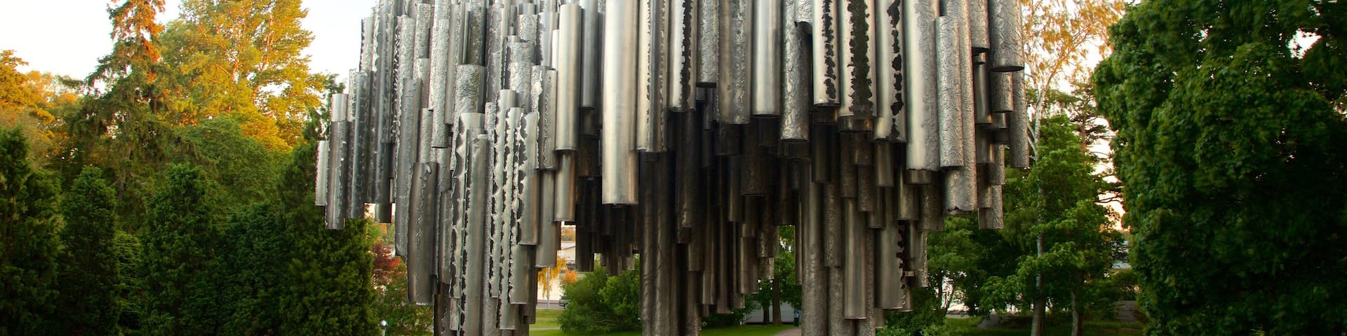 Helsinki which includes a park and a statue or sculpture